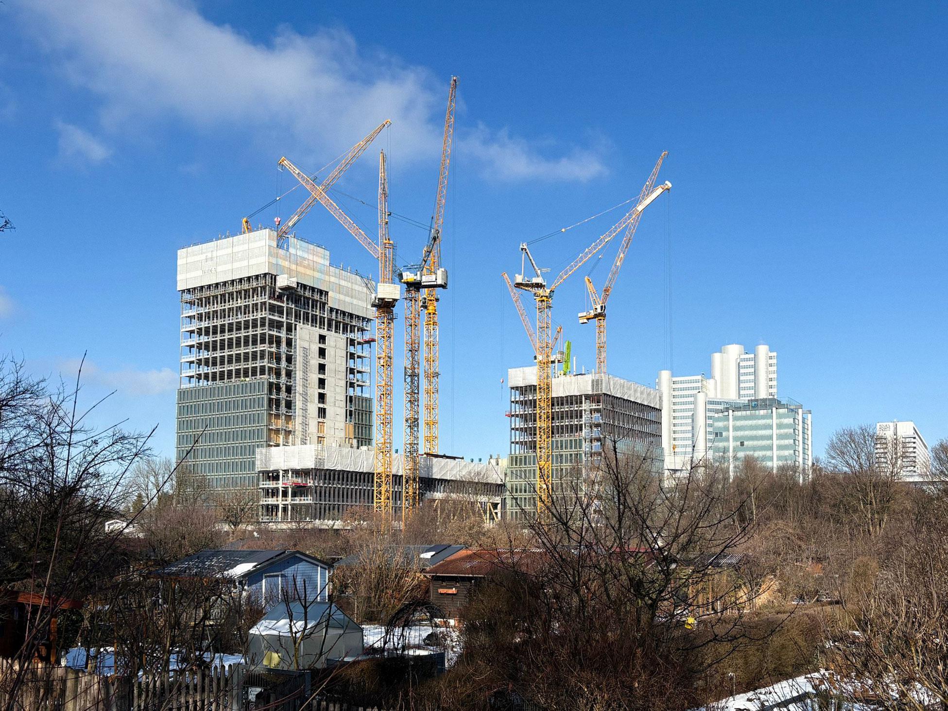 Construction site of the Tridea high-rise project in Munich with multiple cranes