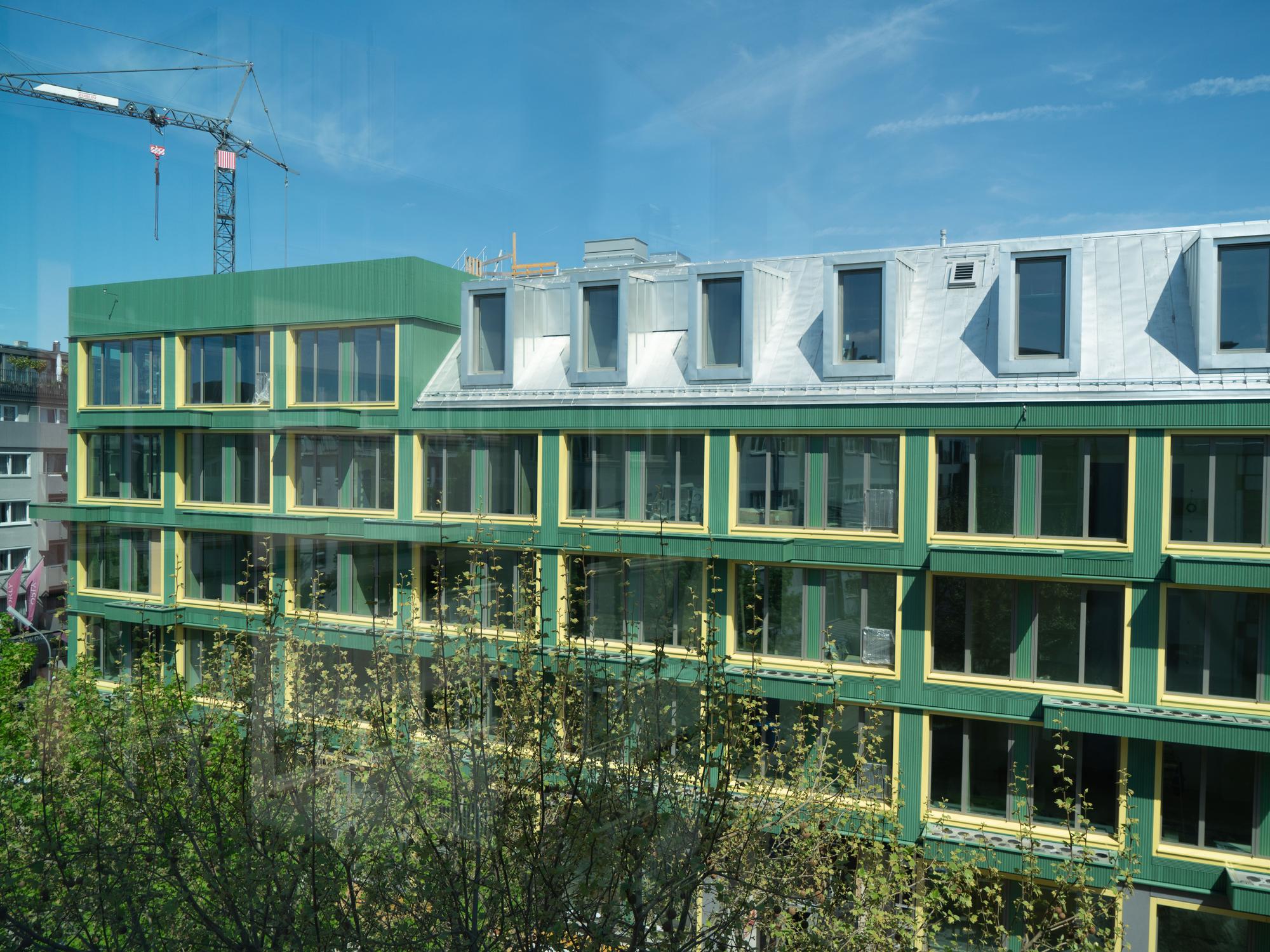 Completed green timber façade of the Vinzent building in Munich